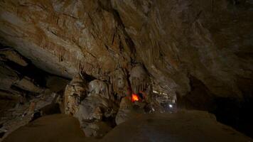 Tourist caves in rocks. Action. Huge rock caves with hiking trails. Inside large rocky cave in dark video