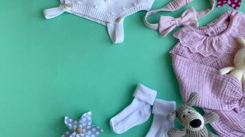 Pink knitted bodysuit with knitted toy, socks and headband. video