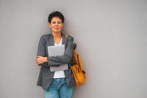 Casual Businesswoman with Laptop Outdoors photo