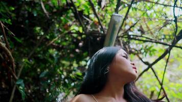 Serene woman enjoying nature, surrounded by lush greenery video