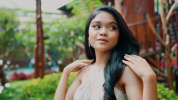 Portrait of a smiling young woman outdoors with a blurred background, exuding confidence and happiness. video