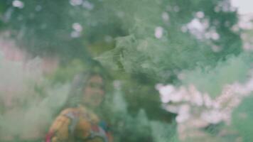 Confident woman in colorful dress walking outdoors with greenery in the background. video