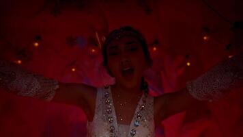 Woman in a white dress posing at a whimsical ice castle entrance. video