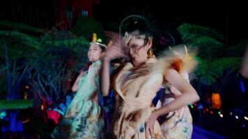 Blurry image of dancers in motion with colorful lighting at a night performance. video