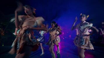 Dancers performing on stage with colorful lighting at a night event. video