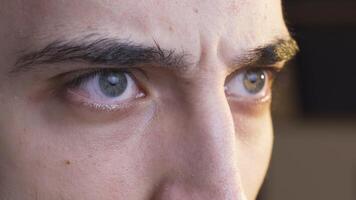 Young man with worry in his pupils. video
