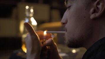 Troubled young man smokes a cigarette. video