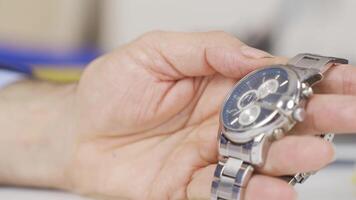 Close-up of hands examining the clock. video