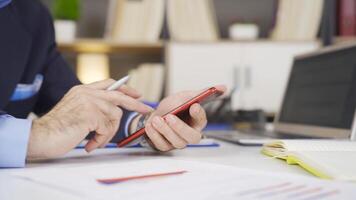 Close-up businessman using phone. video