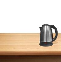 Electric kettle on a wooden table photo