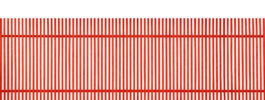 Red vertical wooden fence on white background photo