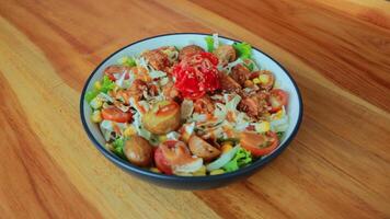 Top view of a bowl of gado-gado sprinkled with peanut sauce, suitable for seasoning satay, ketoprak, and others photo