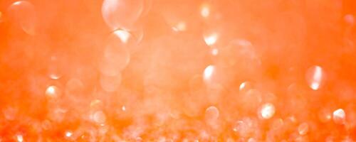 Sparkles defocus light. Orange background and yellow defocus. Background banner size. photo