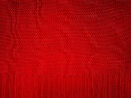 Knitted fabric red macro photo. Element of part of knitted clothes, sweater. photo