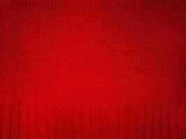 Knitted fabric red macro photo. Element of part of knitted clothes, sweater. photo