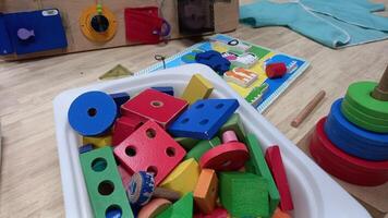 a tray of wooden blocks and toys on a table photo