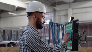 Industrial programmer checking control box status with computer video