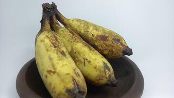 three bananas are sitting in a bowl photo