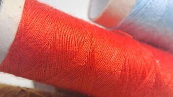 a spool of thread with red and blue colors photo