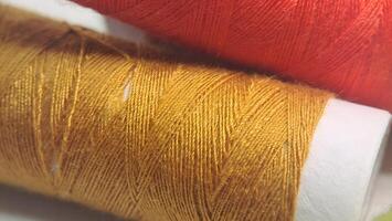 two spools of thread with orange and yellow colors photo