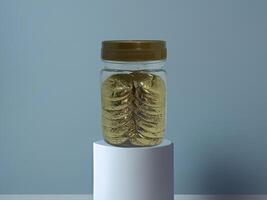 a jar filled with gold coins sitting on a pedestal photo