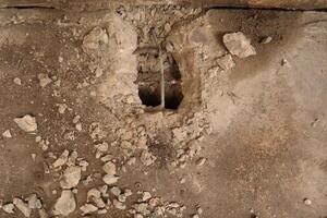 The damaged wall is visible to the internal steel bar. The plaster should be repaired With mortar to make it work. photo