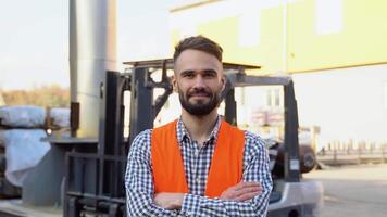 Portrait of professional heavy industry worker wearing uniform against the background of the warehouse loader video