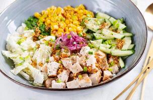 Chinese cabbage salad with chicken meat, corn, cucumber and dressing mustard. Asian food. photo