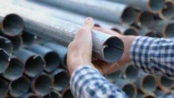 Professional worker in the warehouse of metal products. Factory worker checks the quality of the metal profile video