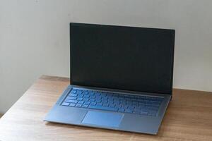 Laptop mockup on wooden table. Laptop with blank screen. photo