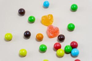 Heart shaped Candy and multi colored candy on Isolated on White Background. photo