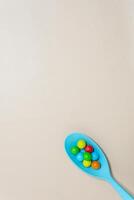 Heart shaped Candy and multi colored marble candy with spoon on Isolated on White Background. photo