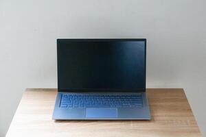 Laptop mockup on wooden table. Laptop with blank screen. photo