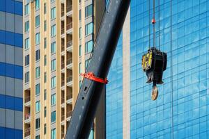 Construction crane With a background of tall buildings photo