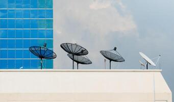 satélite plato en parte superior de un alto edificio foto