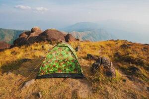 Set up a tent on the hill Full of grasslands photo