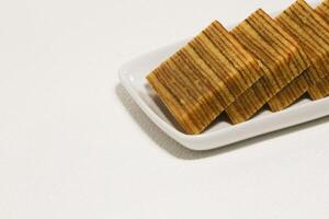Lapis legit or traditional Indonesian sweet lapis cake on a white background photo