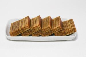Lapis legit or traditional Indonesian sweet lapis cake on a white background photo