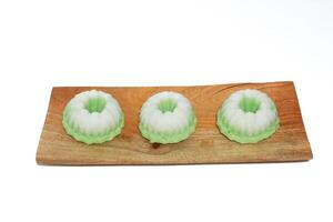 Green putu ayu is an Indonesian local cake made from rice flour and coconut milk with glaze of coconut photo