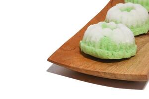 Green putu ayu is an Indonesian local cake made from rice flour and coconut milk with glaze of coconut photo