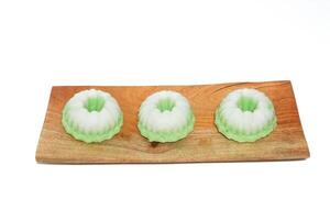 Green putu ayu is an Indonesian local cake made from rice flour and coconut milk with glaze of coconut photo