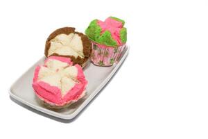 Colorful Steamed Bolu, made from wheat flour, tapioca flour, eggs and sugar. Bolu kukus is an Indonesian traditional sponge cupcake photo