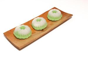 Green putu ayu is an Indonesian local cake made from rice flour and coconut milk with glaze of coconut photo