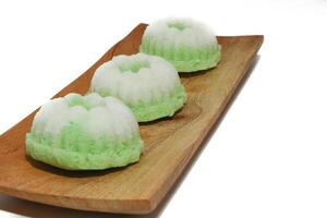 Green putu ayu is an Indonesian local cake made from rice flour and coconut milk with glaze of coconut photo