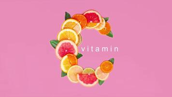 Vitamin C slice of citrus orange, lemon flat lay creative composition. Letters Vitamin pink background video