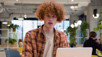 Portrait of surprised male freelancer during break from web working online, hipster blogger sitting in cafe with mockup laptop computer video