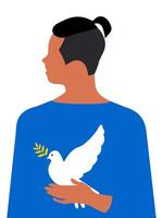 A handsome young guy with a modern teenage haircut holds a white dove of peace in his hands on a vertical white background. vector