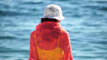 femme Aller dans mer sur plage à le coucher du soleil pendant été vacances vacances au ralenti, fermer, retour voir. poids perte et corps image concept. content femme avec parfait en forme corps jouit mer plage video