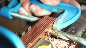 metalworking industry. close up hole drilling in copper bars for electrical connection on lathe boring machine with lubricant video