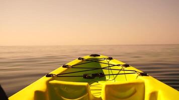 Sea water surface. Camera flies over the calm azure sea with green kayak boat on foreground. Nobody. Holiday recreation concept. Abstract nautical summer ocean nature. Slow motion. Close up video